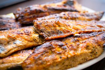 Mackerel fried on the grill, close-up. Cooked fish meat of a pleasant appetizing appearance. High-protein healthy meal for an athlete