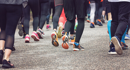 The legs of athletes dressed in special equipment, running a long distance