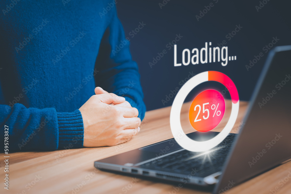 Poster Concept of waiting for load of loading symbol. Young man using a laptop computer for download software and waiting to loading digital business data form website, very slow internet form wifi.