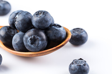 Fresh blueberries in wooden spoon