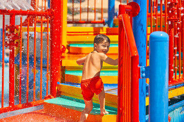 Fototapeta na wymiar Picture of young boy playing in outdoor aqua park
