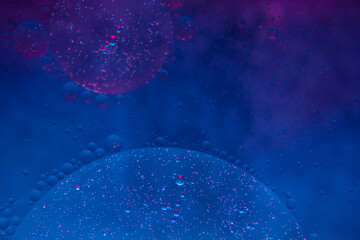 Circles on the water. Oil stains. Spilled fuel. Oil in water. Gasoline in water. Liquid like oil. Bubbles in the water of different colors and sizes. Red, blue, purple and green.