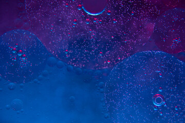 Circles on the water. Oil stains. Spilled fuel. Oil in water. Gasoline in water. Liquid like oil. Bubbles in the water of different colors and sizes. Red, blue, purple and green.