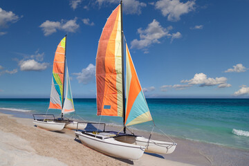 Colorful sailing catamaran on the beach of the Varadero -  Cuba.
Turquoise blue Atlantic water and...