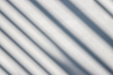 abstract shadow of palm leaves on white concrete wall