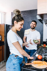 latin couple cooking together in the kitchen healthy food at home in Mexico, Hispanic people	