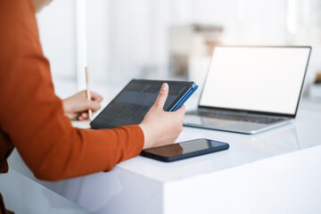 Asian teenage woman study online class at home or cafe by using tablet and laptop, video call with teacher and friends learning, university student studying online concept