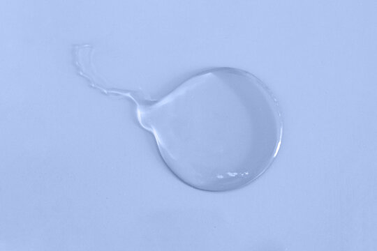 Trasparent smear in shape of spermatozoid on color background.Concept for fertilization