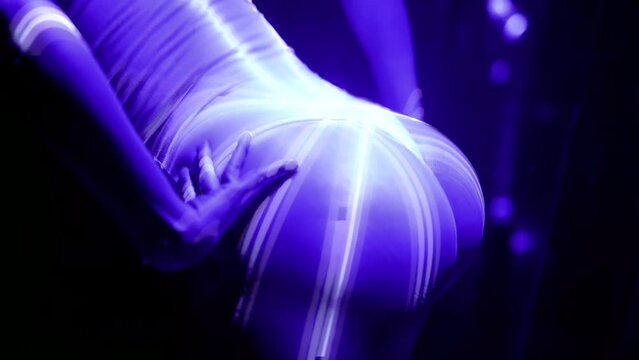 seductive slender woman dancing in room for private dance in strip club, closeup of sexy butt