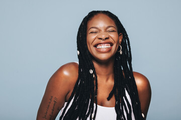 Black woman smiling in a studio - Powered by Adobe