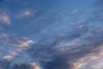 Naklejka na ściany i meble lonely plane between sunset clouds, Majorca, Balearic Islands, Spain