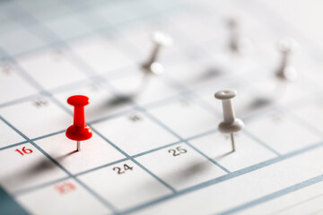 Calendar appointment thumbtacks in various dates on calendar diary