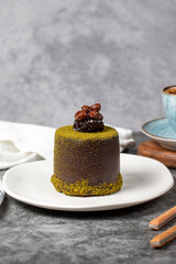 Chocolate cream cake. Cake with pistachio and chocolate cream on a dark background. patisserie desserts