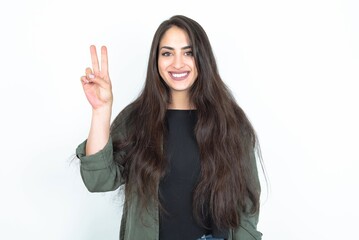 young brunette woman wearing casual clothes over white studio background showing and pointing up with fingers number two while smiling confident and happy.