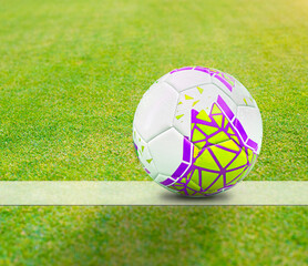 Traditional soccer ball with print on soccer field