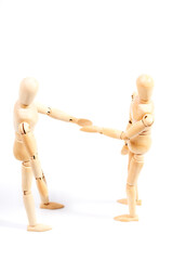 Two mannequins closing a deal by shaking hands on a white background. Concept of business