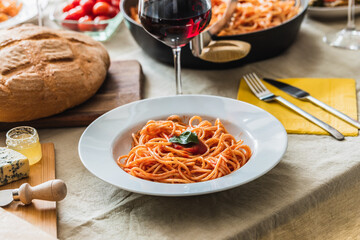Table setting with selective focus on a plate of spaghetti