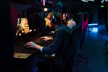 Team of gamers playing online game on tournament in cybersport club