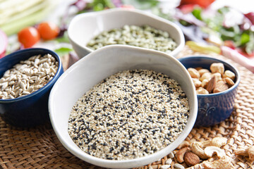 Close-up, a bowl of chia seeds and other healthy foods on the kitchen table.