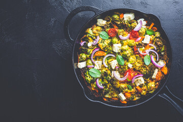  Roasted vegetables mix with feta cheese in cast iron grilling pan