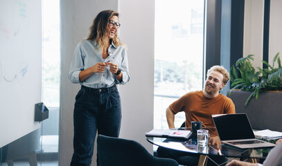Caucasian business woman engaging in an active discussion with her team in a meeting