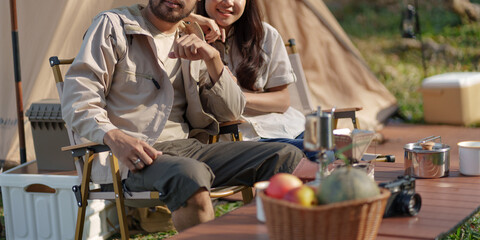 Asian couple camping outdoors. Couple travelers holding hands together love and Travel Lifestyle.