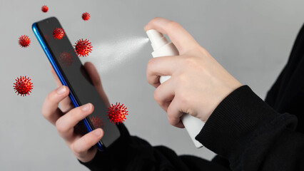 Human hand spray alcohol, disinfectant spray on mobile phone, prevent infection by virus, germs,...