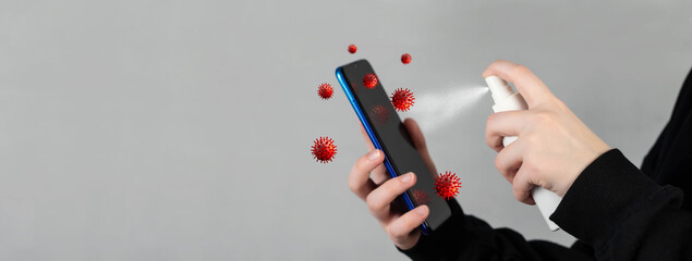 Human hand spray alcohol, disinfectant spray on mobile phone, prevent infection by virus, germs, bacteria. Smartphone with infectious bacteria and germs on the display.
