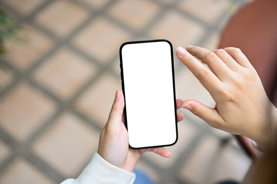 A smartphone white screen mockup is in a woman's hands over blurred background.