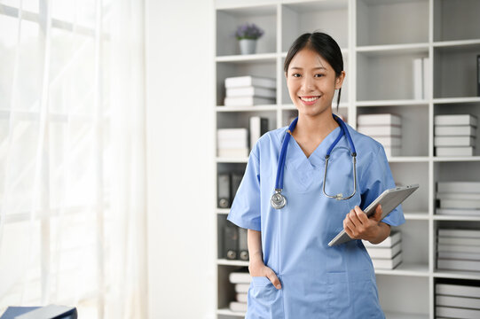 Portrait of young Asian medical student smiling and standing in the study room