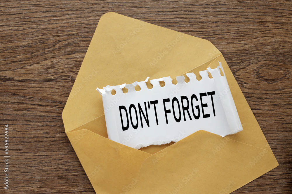 Poster do not forget beautiful envelope on a wooden background with text on torn paper