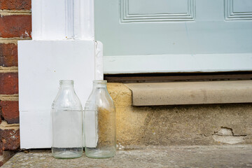 English village doorstep and empty milk bottles