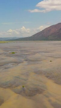 Top view of shallow river in the dry season in a mountain valley. Bucao river. Luzon, Philippines.