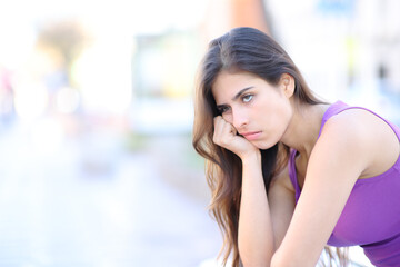 Bored woman waiting in the street