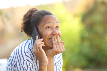 Fototapeta na wymiar Funny black woman calling on phone