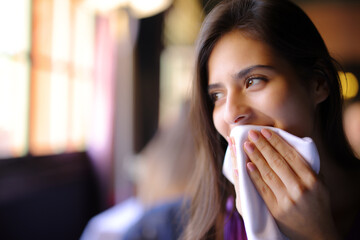 Happy woman using napkin in a restaurant