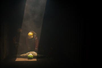 The two firefighters are carefully checking the pulse on the dummy models to practice for real-life emergencies in the dark room with soft light.