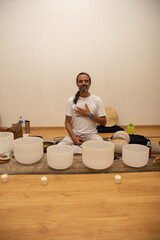 master of a meditation ceremony playing instruments