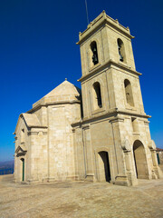 Fototapeta na wymiar Nossa Senhora da Graça sanctuary, Monte Farinha, Portugal, church against blue clear sky