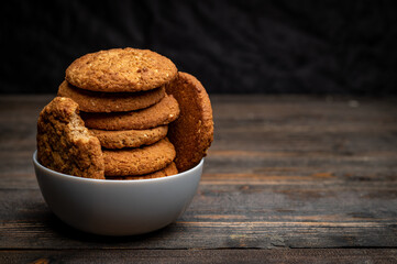homemade oatmeal cookies cinnamon isolated on dark wooden table with copy space