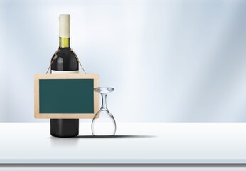 Alcohol bottle of wine and glass with blank sign.
