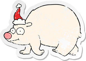 hand drawn distressed sticker cartoon of a walking polar bear wearing santa hat