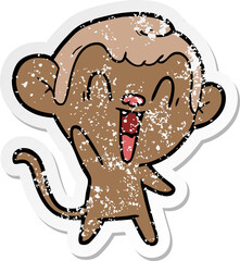 distressed sticker of a cartoon laughing monkey