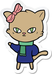sticker of a cute cartoon cat in winter clothes