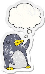cartoon penguin with thought bubble as a distressed worn sticker