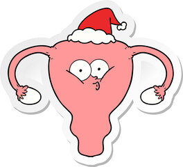 hand drawn sticker cartoon of a uterus wearing santa hat