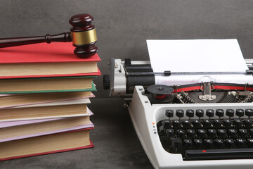 Writers desk - typewriter, books and judge's gavel, copyright protection law concept