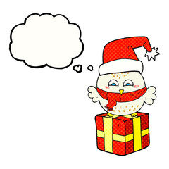 freehand drawn thought bubble cartoon cute christmas owl on wrapped present
