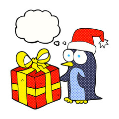 freehand drawn thought bubble cartoon christmas penguin with present