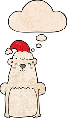 cartoon bear wearing christmas hat with thought bubble in grunge texture style